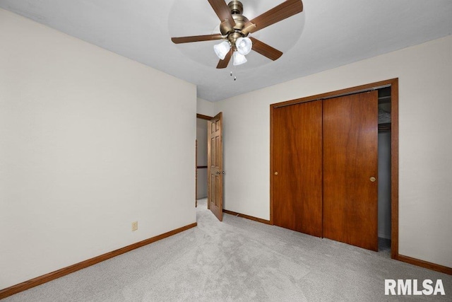 unfurnished bedroom featuring carpet floors, a closet, a ceiling fan, and baseboards