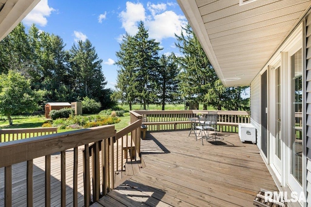 wooden deck featuring an outbuilding