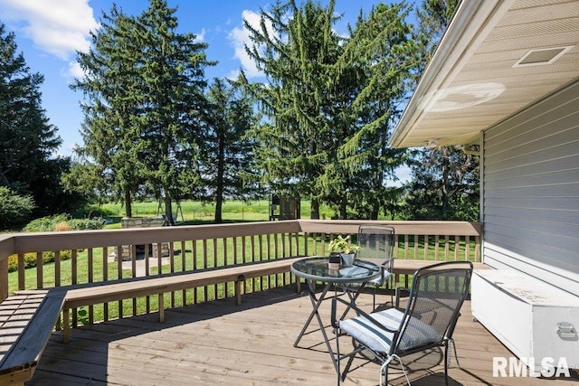 wooden terrace with a yard