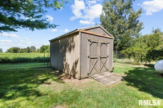 view of shed featuring fence