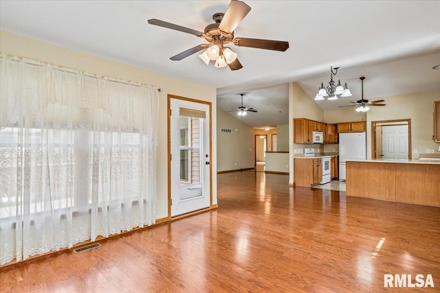 5200 Villa Dr, Davenport, IA 52806 - unfurnished living room with ceiling fan, visible vents, vaulted ceiling, baseboards, and light wood finished floors
