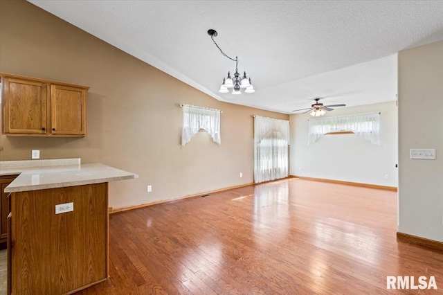 5200 Villa Dr, Davenport, IA 52806 - kitchen with a healthy amount of sunlight, vaulted ceiling, hardwood / wood-style floors, and open floor plan