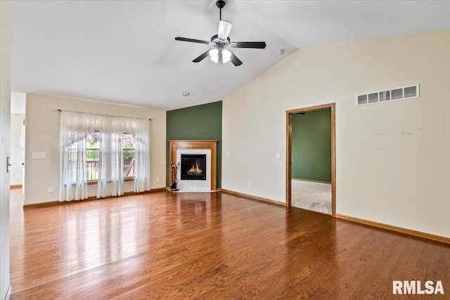 5200 Villa Dr, Davenport, IA 52806 - unfurnished living room with ceiling fan, a glass covered fireplace, baseboards, wood finished floors, and visible vents