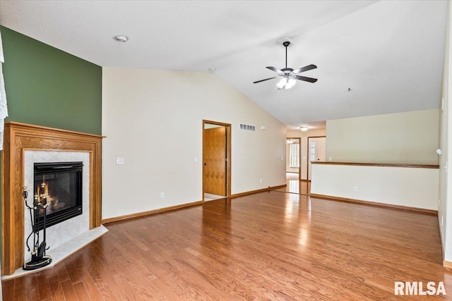 5200 Villa Dr, Davenport, IA 52806 - unfurnished living room featuring a ceiling fan, baseboards, wood finished floors, a high end fireplace, and vaulted ceiling