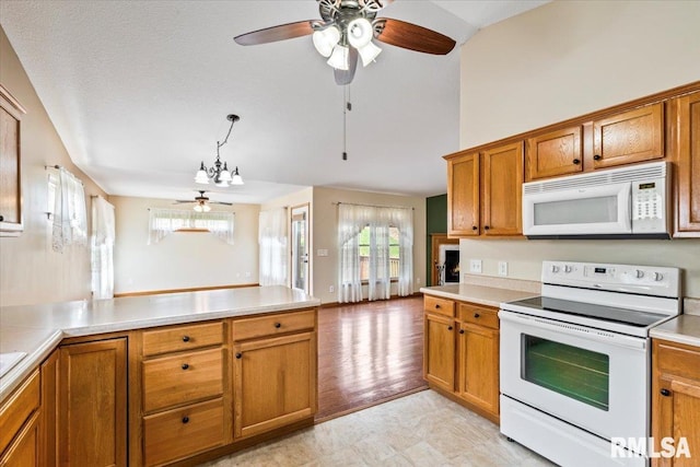 5200 Villa Dr, Davenport, IA 52806 - kitchen featuring white appliances, a ceiling fan, brown cabinets, and light countertops