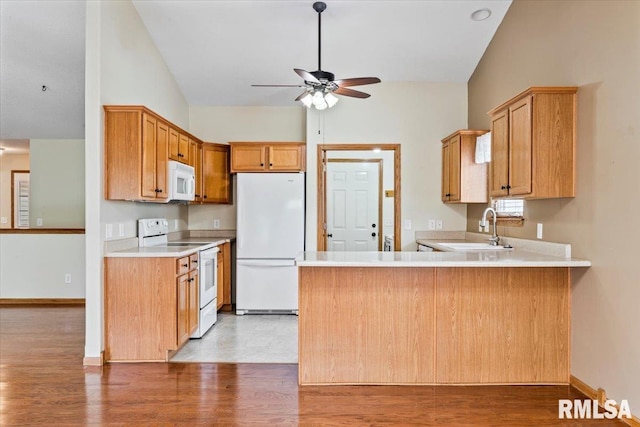 5200 Villa Dr, Davenport, IA 52806 - kitchen with a ceiling fan, white appliances, a sink, light wood finished floors, and vaulted ceiling