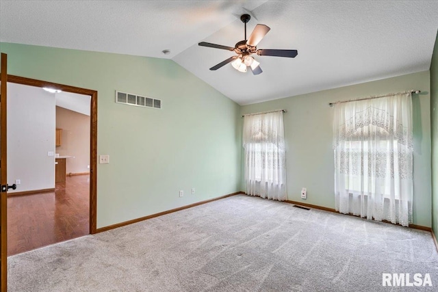 5200 Villa Dr, Davenport, IA 52806 - carpeted spare room featuring a ceiling fan, baseboards, visible vents, and lofted ceiling