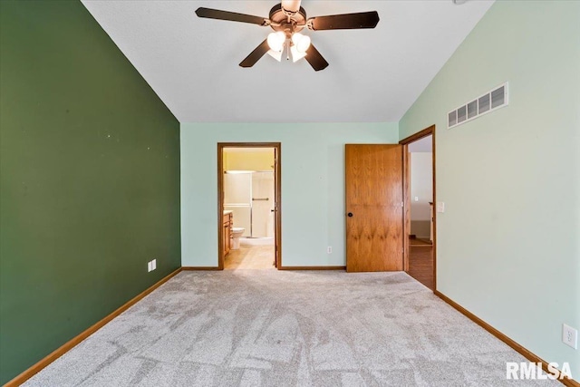5200 Villa Dr, Davenport, IA 52806 - unfurnished bedroom featuring carpet flooring, baseboards, ensuite bathroom, vaulted ceiling, and visible vents