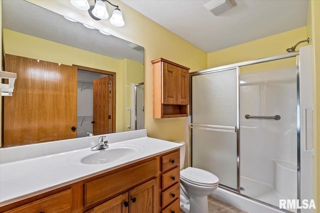 5200 Villa Dr, Davenport, IA 52806 - bathroom featuring visible vents, a stall shower, toilet, and vanity