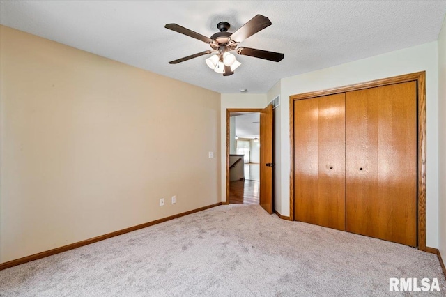5200 Villa Dr, Davenport, IA 52806 - unfurnished bedroom featuring a ceiling fan, baseboards, carpet, and a closet
