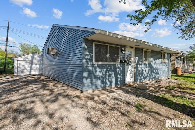 back of house featuring an outbuilding and a garage