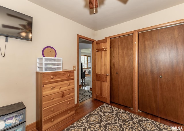bedroom featuring two closets and dark wood finished floors