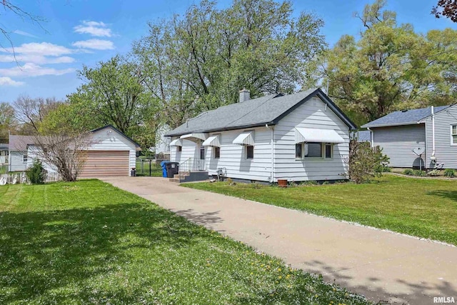 bungalow-style house featuring a garage, an outdoor structure, a chimney, and a front yard