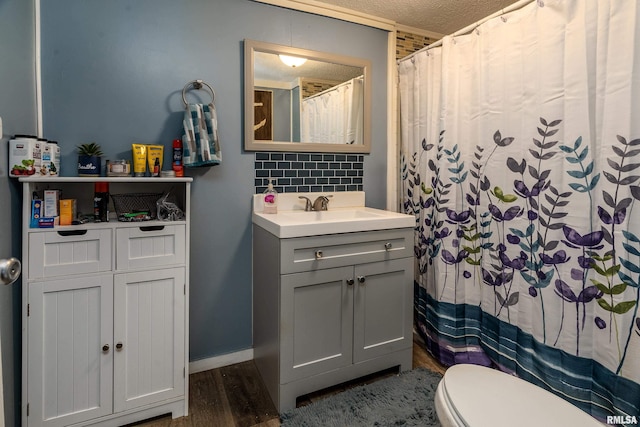 510 W Idaho Ave, Carterville, IL 62918 - full bath with wood finished floors, decorative backsplash, vanity, toilet, and curtained shower