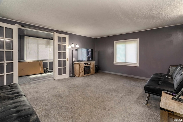 510 W Idaho Ave, Carterville, IL 62918 - living area with a textured ceiling, carpet, french doors, and baseboards