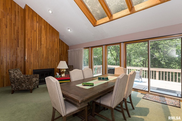 28018 230th St, Le Claire, IA 52753 - dining space with carpet flooring, high vaulted ceiling, and wood walls