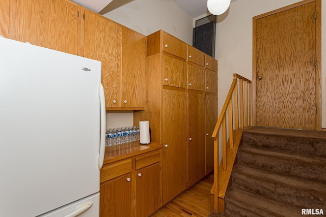 28018 230th St, Le Claire, IA 52753 - staircase featuring wood finished floors