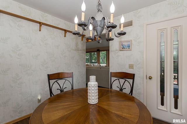 28018 230th St, Le Claire, IA 52753 - dining room featuring wallpapered walls, an inviting chandelier, and visible vents