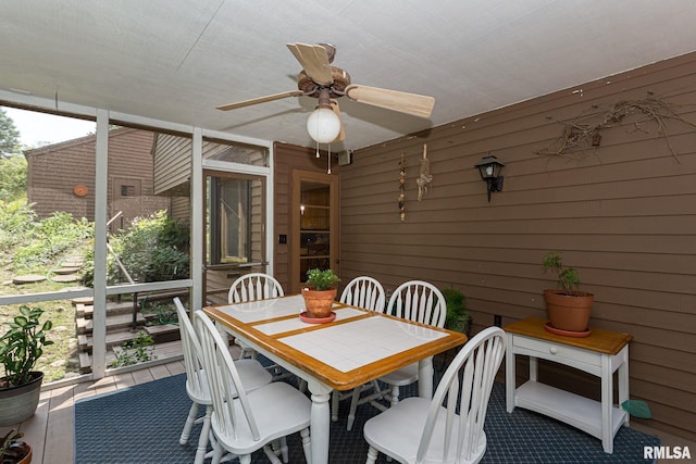 28018 230th St, Le Claire, IA 52753 - sunroom / solarium with outdoor dining area and ceiling fan