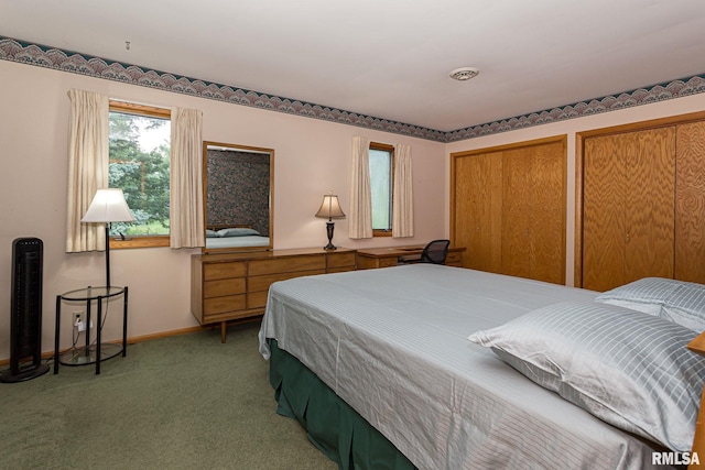 28018 230th St, Le Claire, IA 52753 - bedroom with multiple closets, baseboards, and light colored carpet