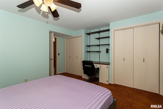 28018 230th St, Le Claire, IA 52753 - bedroom featuring dark carpet, ceiling fan, and two closets