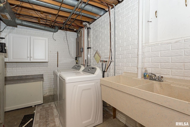 28018 230th St, Le Claire, IA 52753 - washroom featuring a sink, cabinet space, electric panel, and washer and dryer