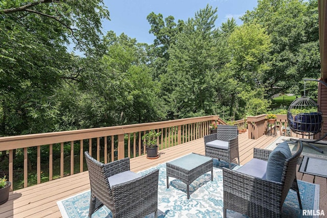 28018 230th St, Le Claire, IA 52753 - deck featuring an outdoor living space