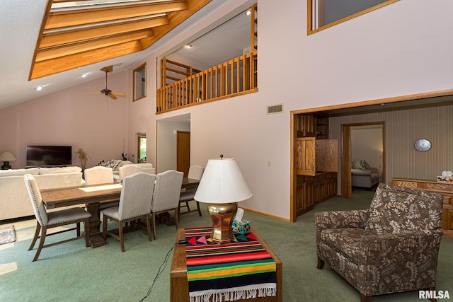 28018 230th St, Le Claire, IA 52753 - carpeted living room with visible vents, ceiling fan, and high vaulted ceiling