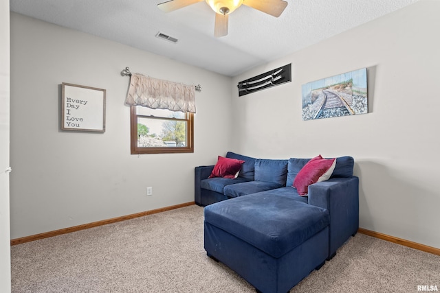 6135 Hillandale Rd, Davenport, IA 52806 - living area with ceiling fan, carpet floors, a textured ceiling, baseboards, and visible vents
