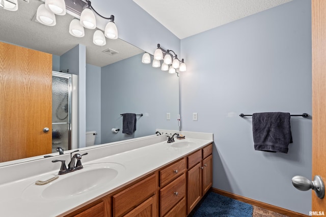 6135 Hillandale Rd, Davenport, IA 52806 - full bathroom with double vanity, a sink, a stall shower, and visible vents