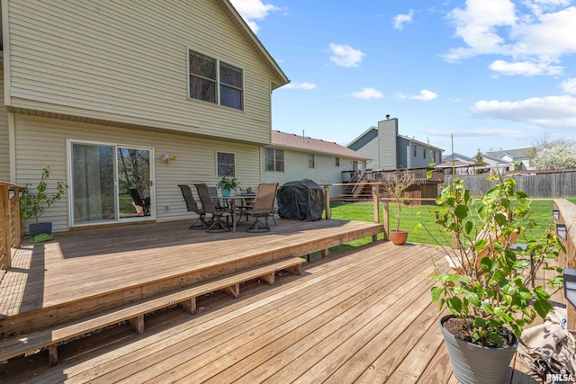 6135 Hillandale Rd, Davenport, IA 52806 - wooden deck with a yard, a fenced backyard, and outdoor dining space