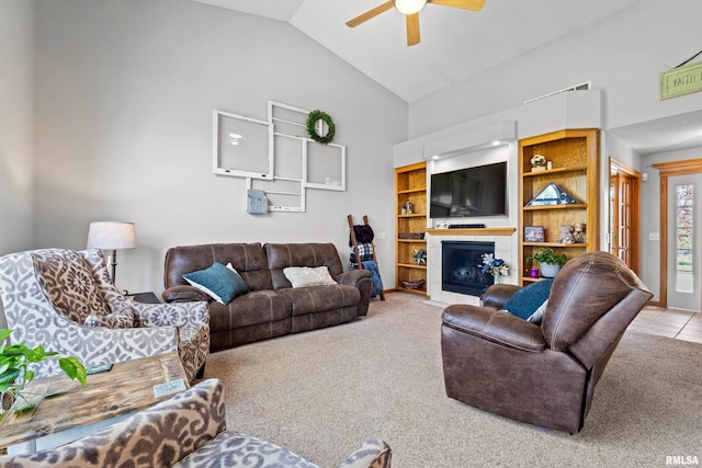 6135 Hillandale Rd, Davenport, IA 52806 - carpeted living area with high vaulted ceiling, a fireplace, and a ceiling fan