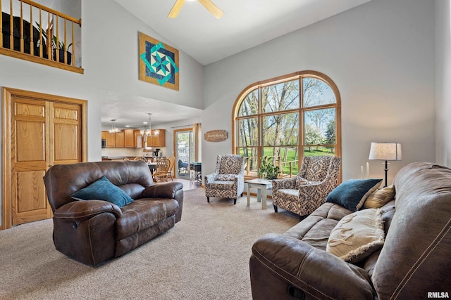 6135 Hillandale Rd, Davenport, IA 52806 - carpeted living room with high vaulted ceiling and ceiling fan with notable chandelier