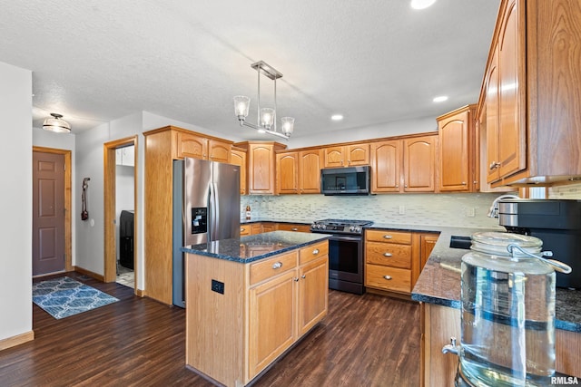 6135 Hillandale Rd, Davenport, IA 52806 - kitchen with dark stone counters, a center island, stainless steel appliances, and dark wood-style floors