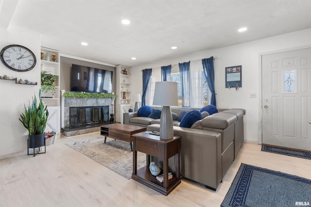 4012 172nd St N, East Moline, IL 61244 - living room featuring recessed lighting, baseboards, a glass covered fireplace, and light wood finished floors