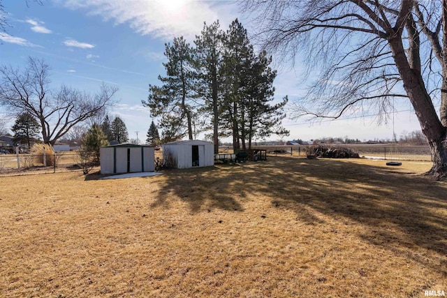 4012 172nd St N, East Moline, IL 61244 - view of yard featuring a shed, an outbuilding, and fence