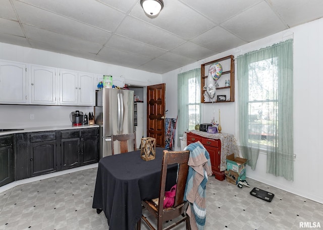 dining room with a paneled ceiling and light floors