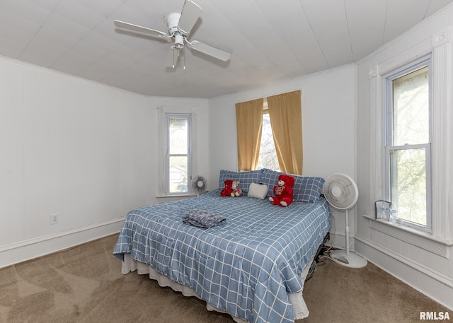 bedroom with carpet floors, a ceiling fan, baseboards, and crown molding