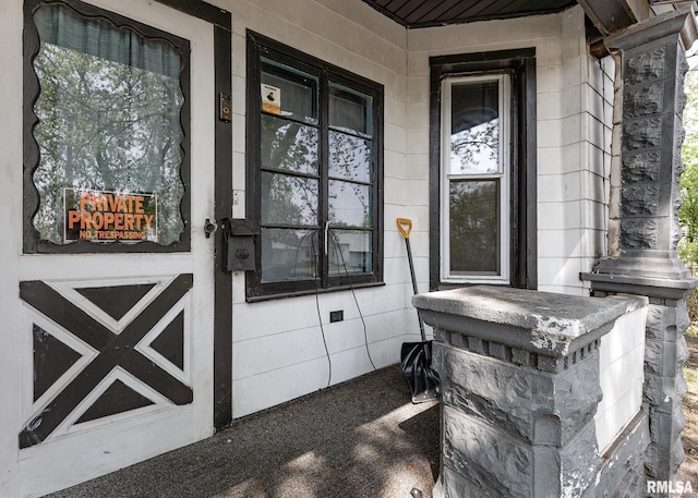 doorway to property featuring covered porch