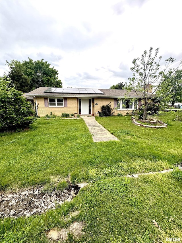 1001 W 6th St, West Frankfort, IL 62896 - ranch-style home featuring brick siding, roof mounted solar panels, and a front lawn