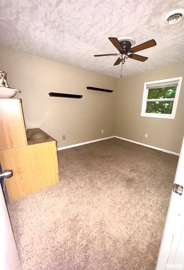 1001 W 6th St, West Frankfort, IL 62896 - unfurnished living room with carpet floors, ceiling fan, a textured ceiling, and visible vents