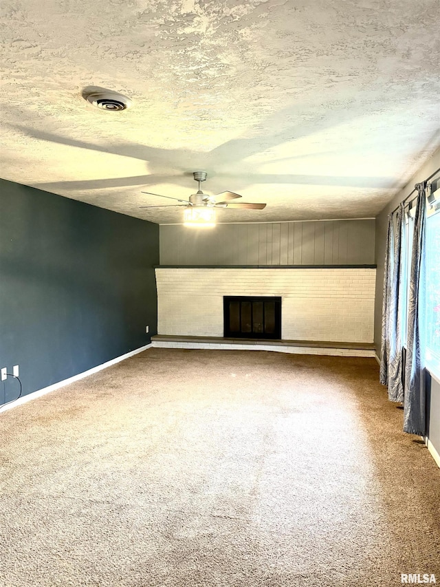 1001 W 6th St, West Frankfort, IL 62896 - unfurnished living room featuring baseboards, carpet, ceiling fan, and a fireplace