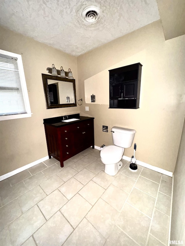 1001 W 6th St, West Frankfort, IL 62896 - bathroom featuring visible vents, a textured ceiling, tile patterned floors, and vanity