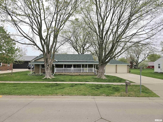 ranch-style house with concrete driveway and a front lawn