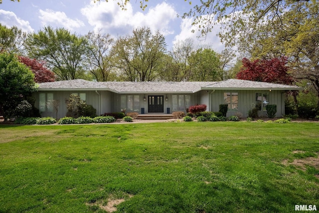 view of front facade with a front lawn and board and batten siding