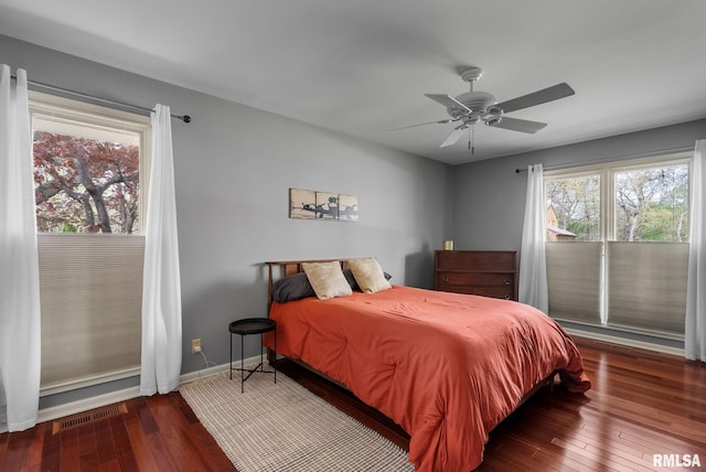 bedroom with visible vents, access to exterior, baseboards, ceiling fan, and hardwood / wood-style flooring