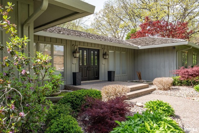 view of exterior entry featuring board and batten siding
