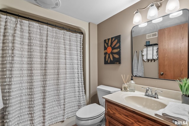 bathroom with vanity, shower / bath combo, toilet, and visible vents