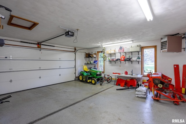 garage with a garage door opener and a heating unit