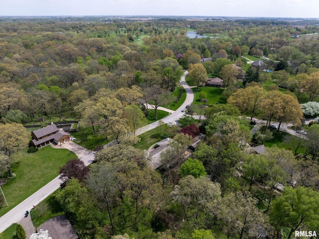 birds eye view of property with a water view and a wooded view